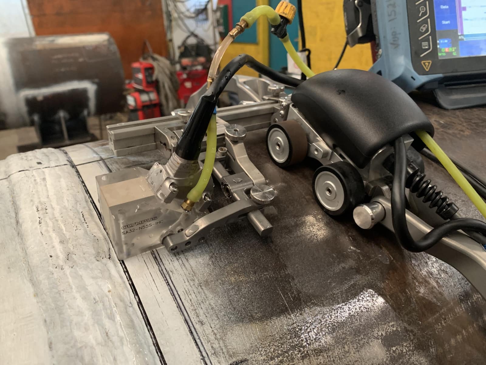 Phased array ultrasonic inspection equipment scanning a weld